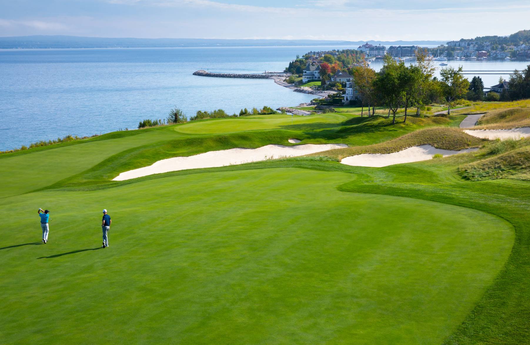 Golfers on The Links course swinging toward Bay Harbor on Lake Michigan, Bay Harbor Golf Club