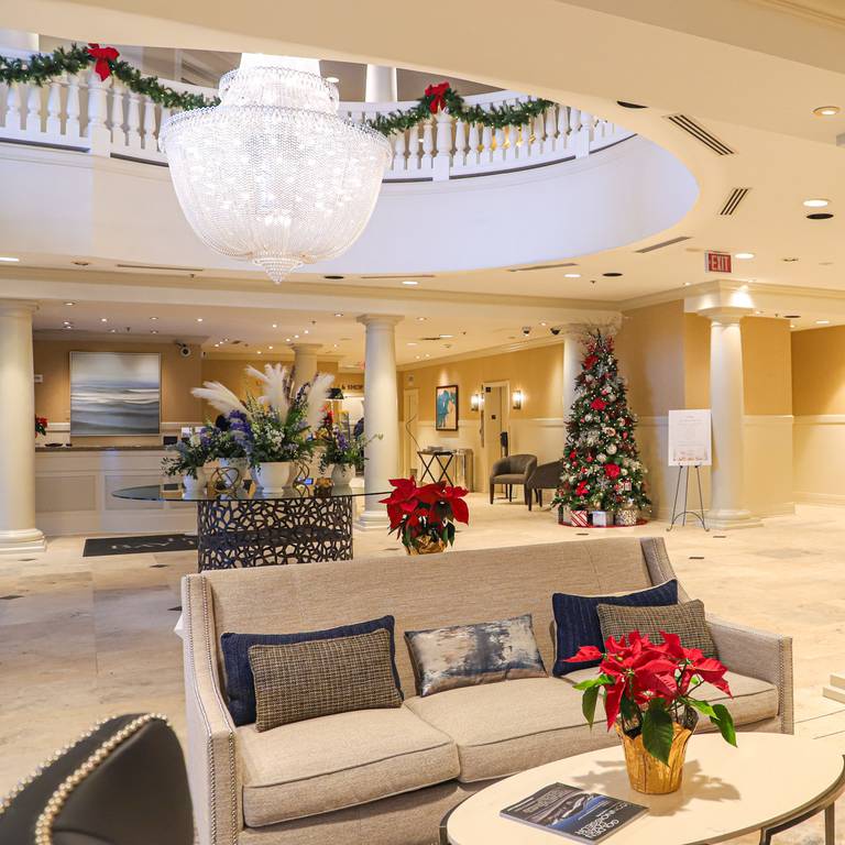 Christmas lobby decor with red details, poinsettias at Inn at Bay Harbor