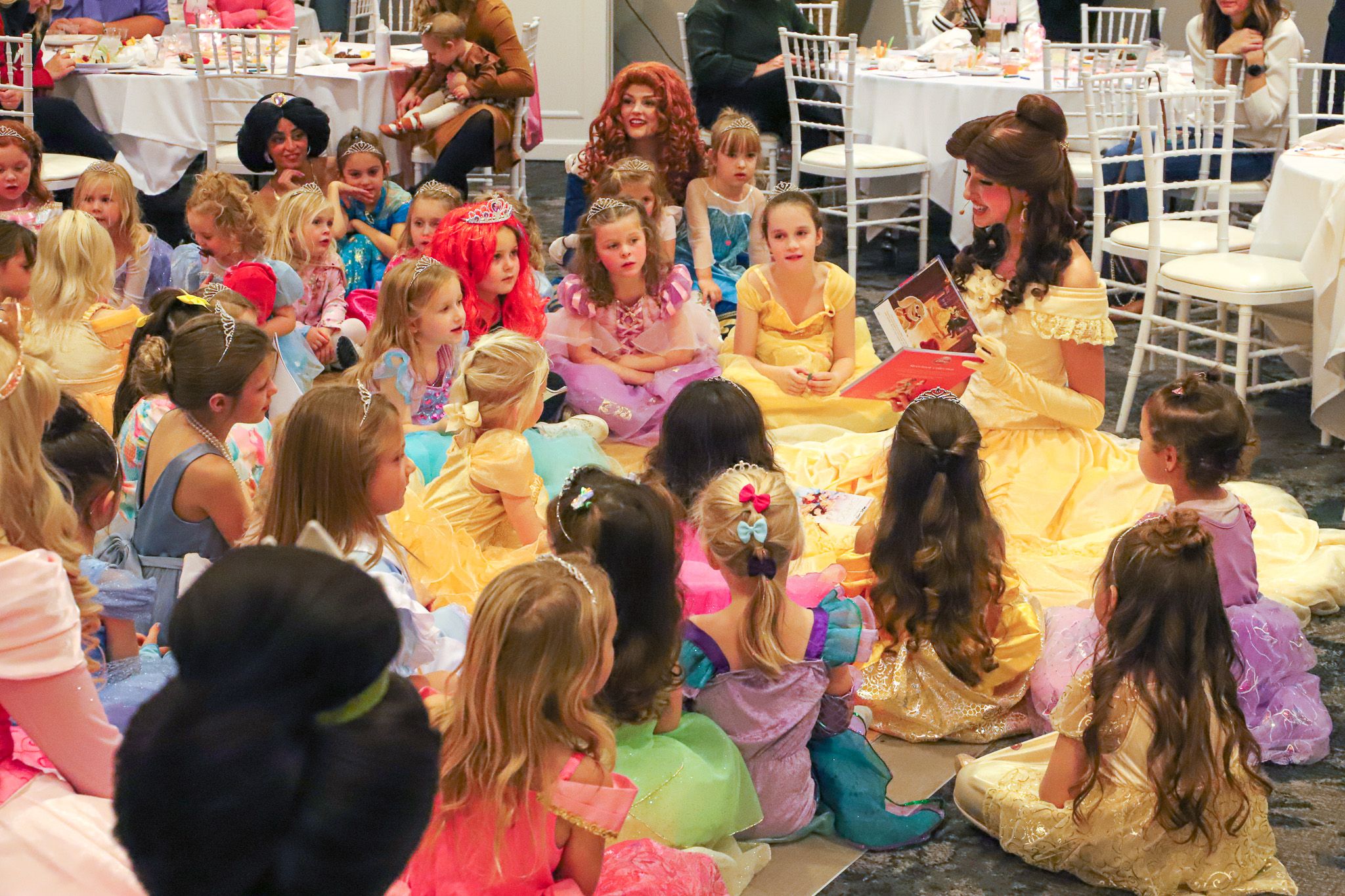 Belle character reads story to Princess Gala young guests