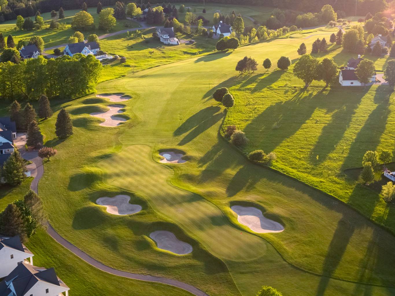 A drone view of Crooked Tree Golf Club with cottages along the course