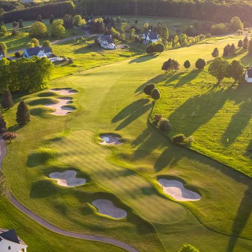 A drone view of Crooked Tree Golf Club with cottages along the course