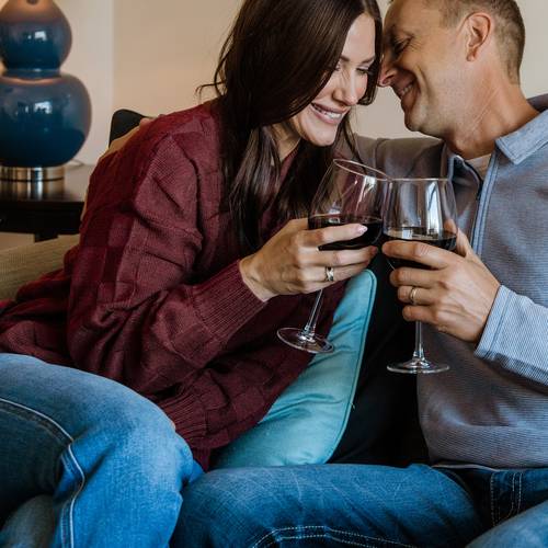 Romantic couple snuggles with red wine, Inn at Bay Harbor Master Suite