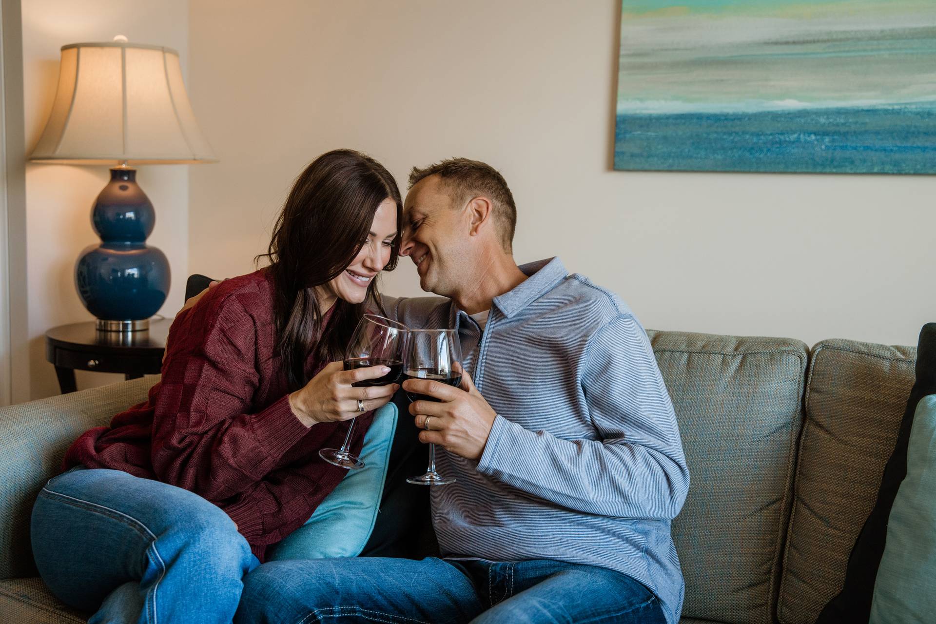Romantic couple snuggles with red wine, Inn at Bay Harbor Master Suite