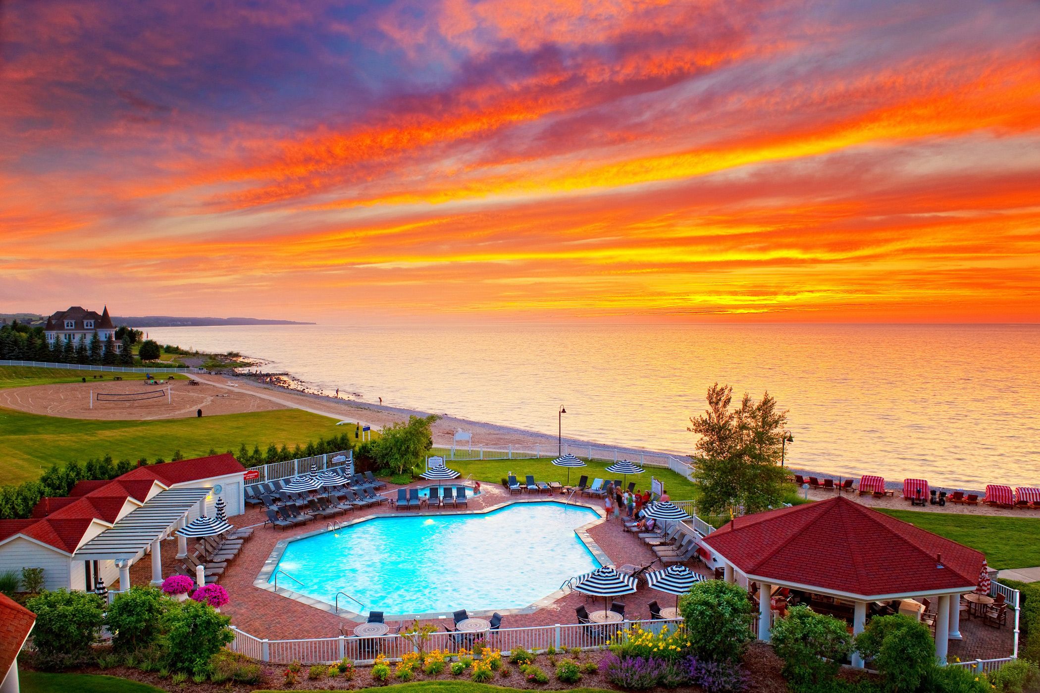 A pool scene with a vibrant sunset