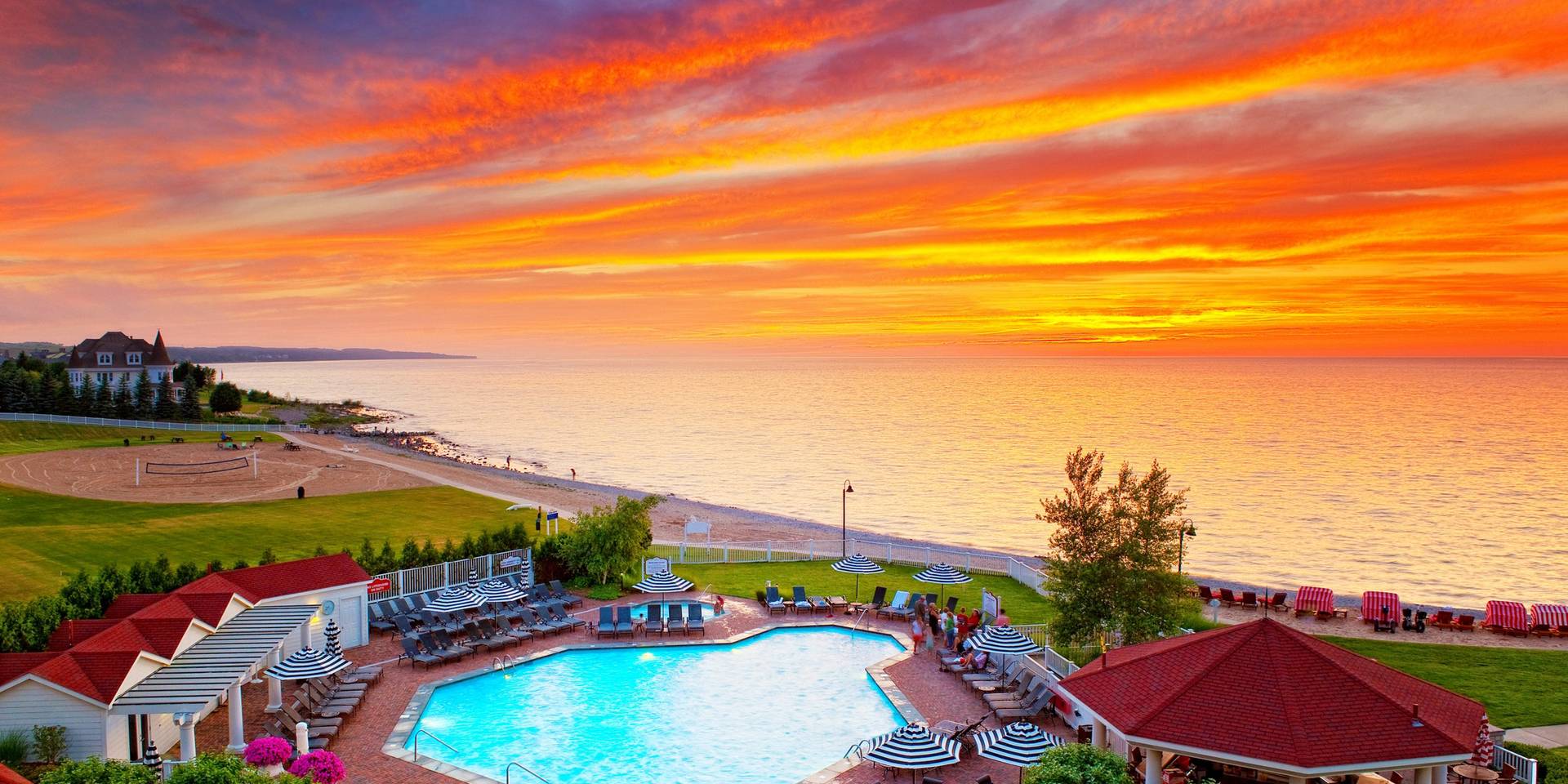 A pool scene with a vibrant sunset