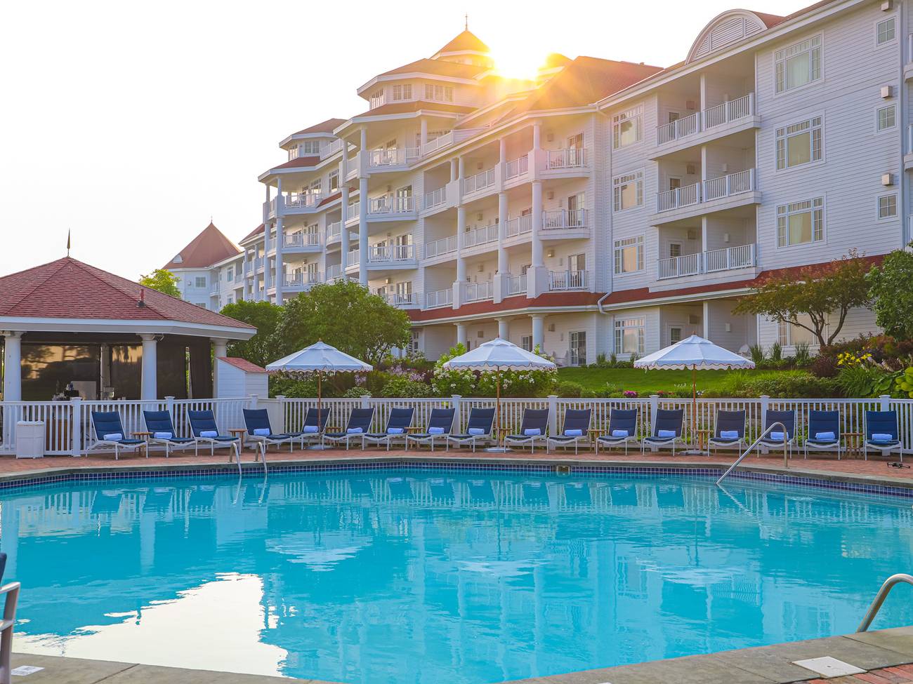 Sun rises over Inn at Bay Harbor, calm outdoor pool view