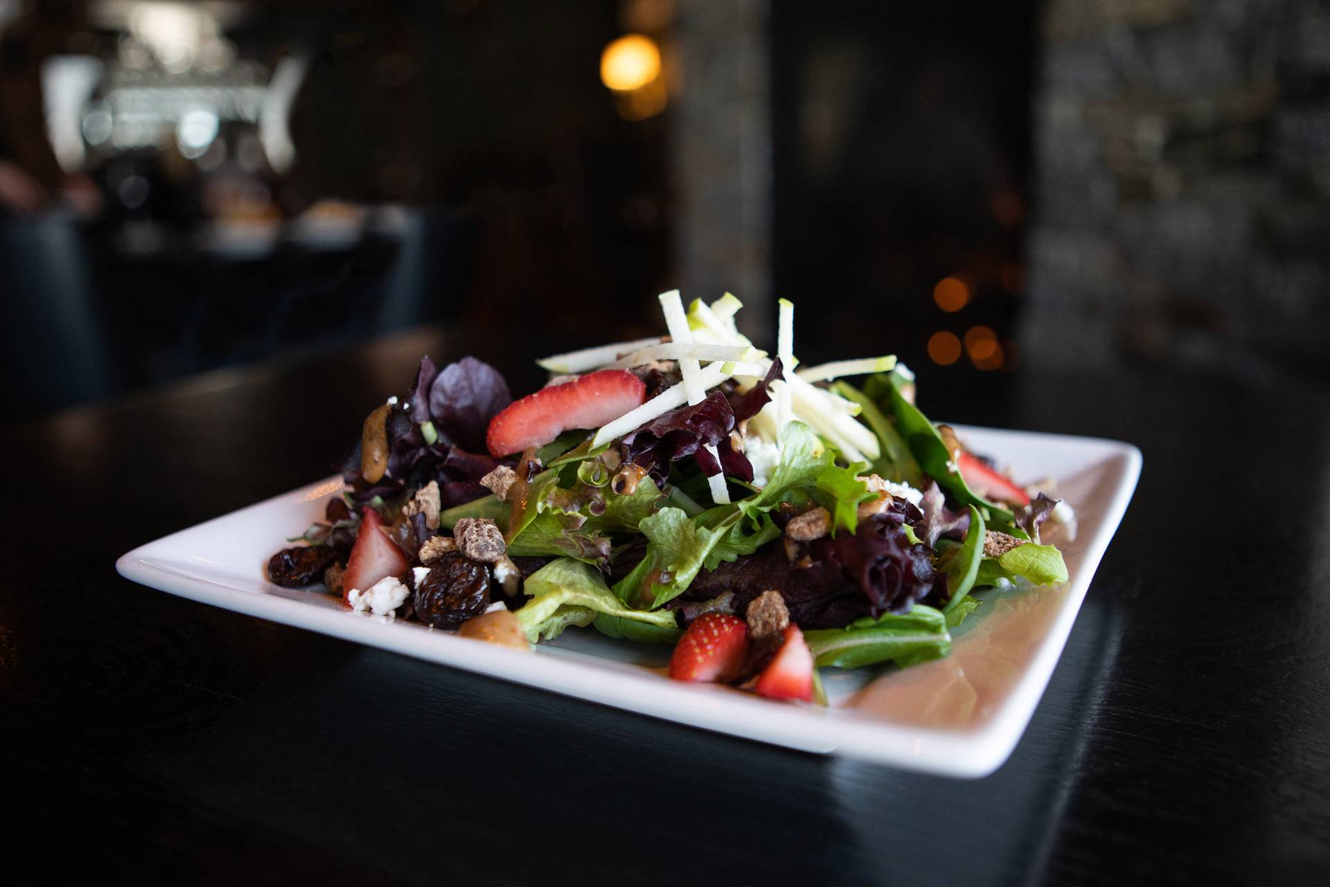 Detail of Vintage Salad, with vibrant greens, strawberries, apple, and pecans