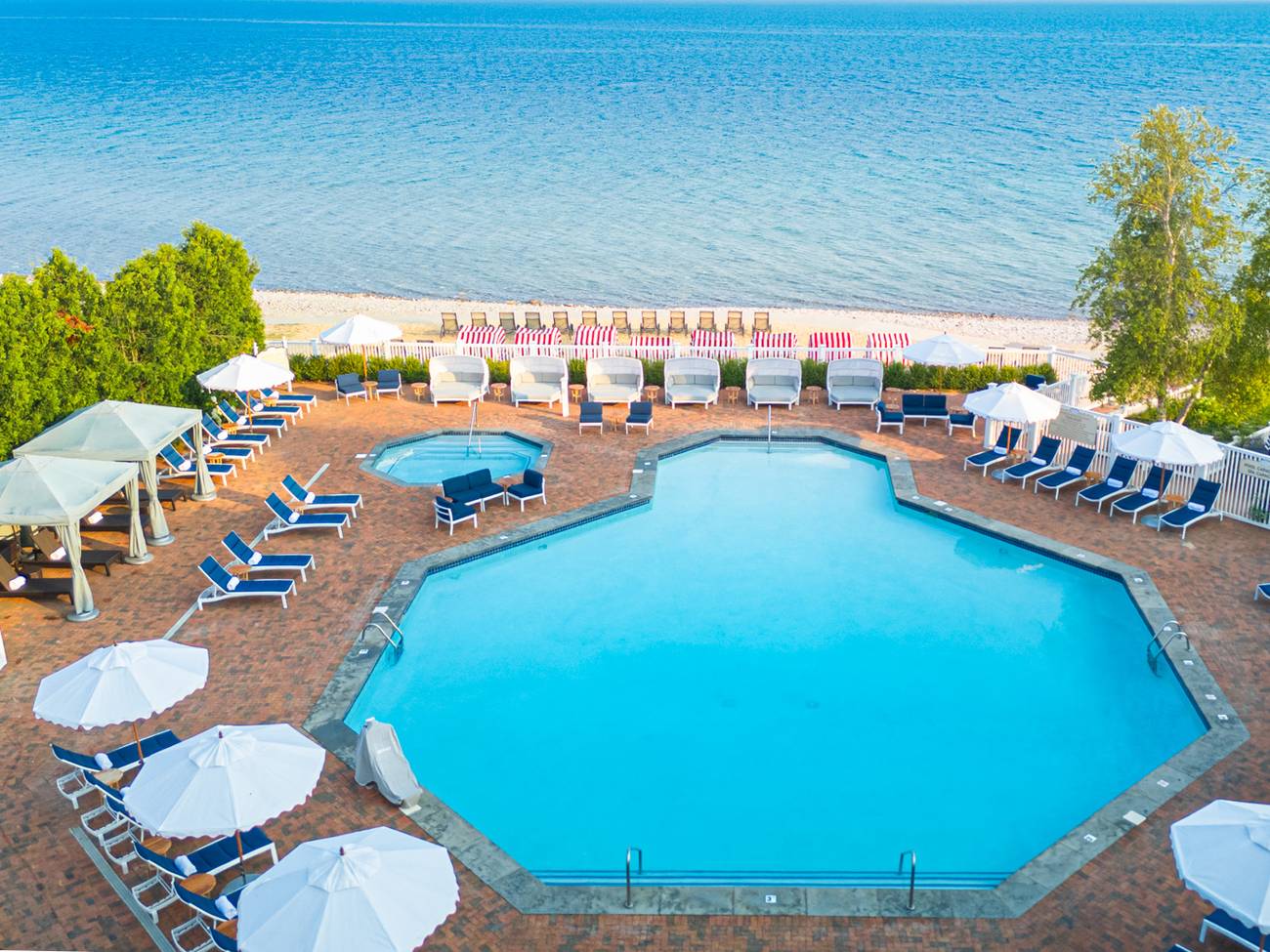 Looking down view of Inn at Bay Harbor pool, furniture, and Lake Michigan