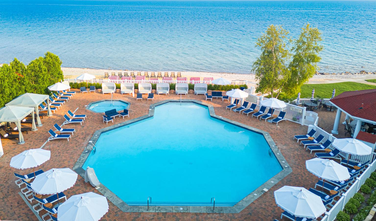 Looking down view of Inn at Bay Harbor pool, furniture, and Lake Michigan