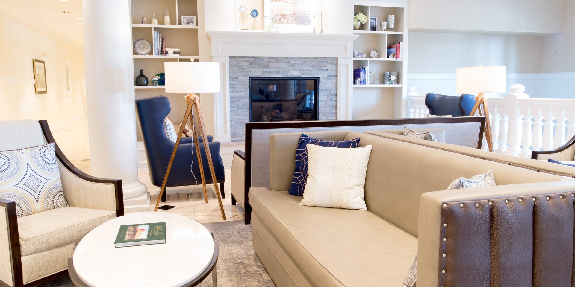 Inn at Bay Harbor lobby loving area couches, chairs, and tables near fireplace
