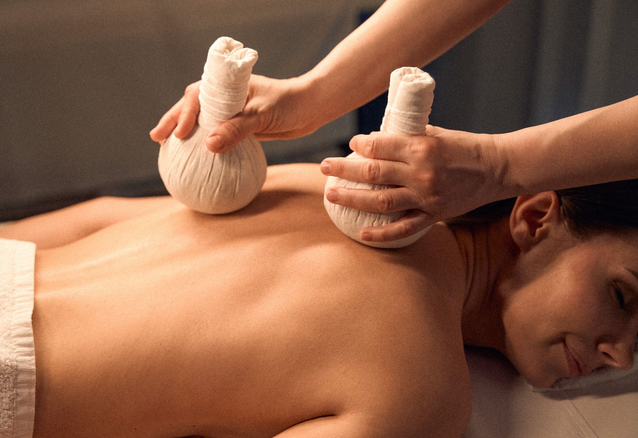 Massage therapist with compress bags, The Spa Herbal Poultice Massage