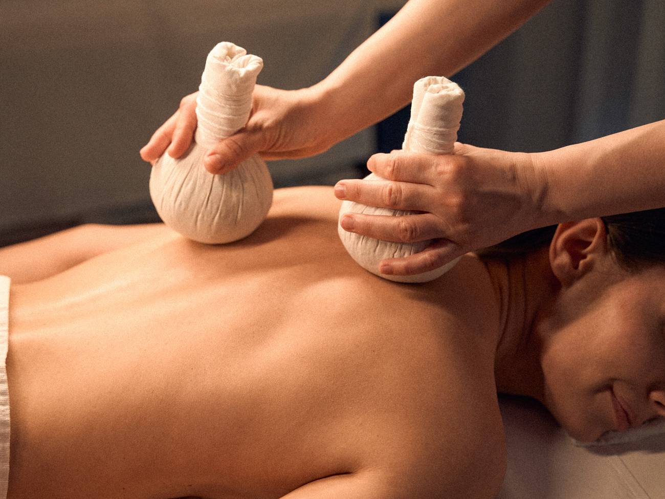 Massage therapist with compress bags, The Spa Herbal Poultice Massage