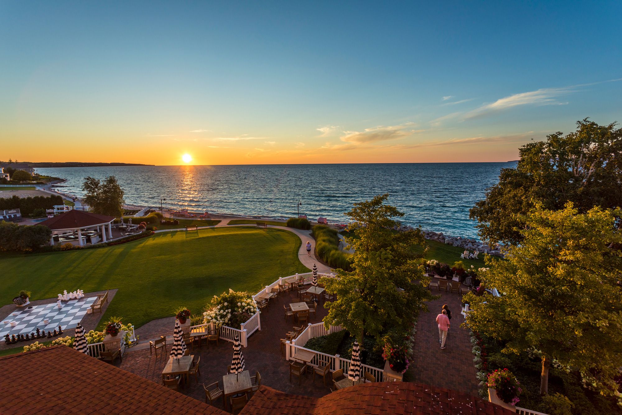 Orange sunset gilds Lake Michigan, Inn at Bay Harbor grounds and dining patios