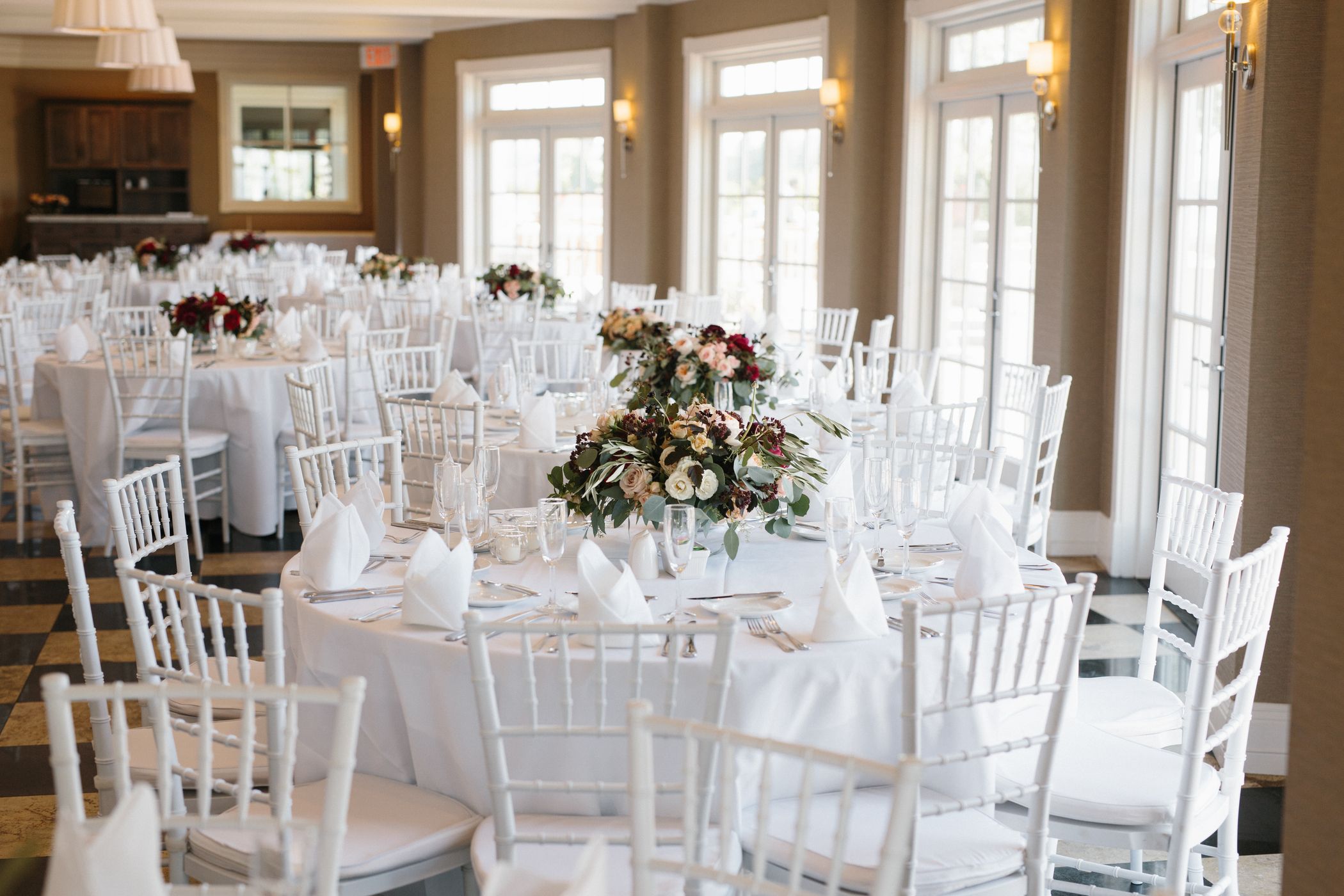 Wedding reception decor, place settings on white tables, Sagamore Room Inn at Bay Harbor