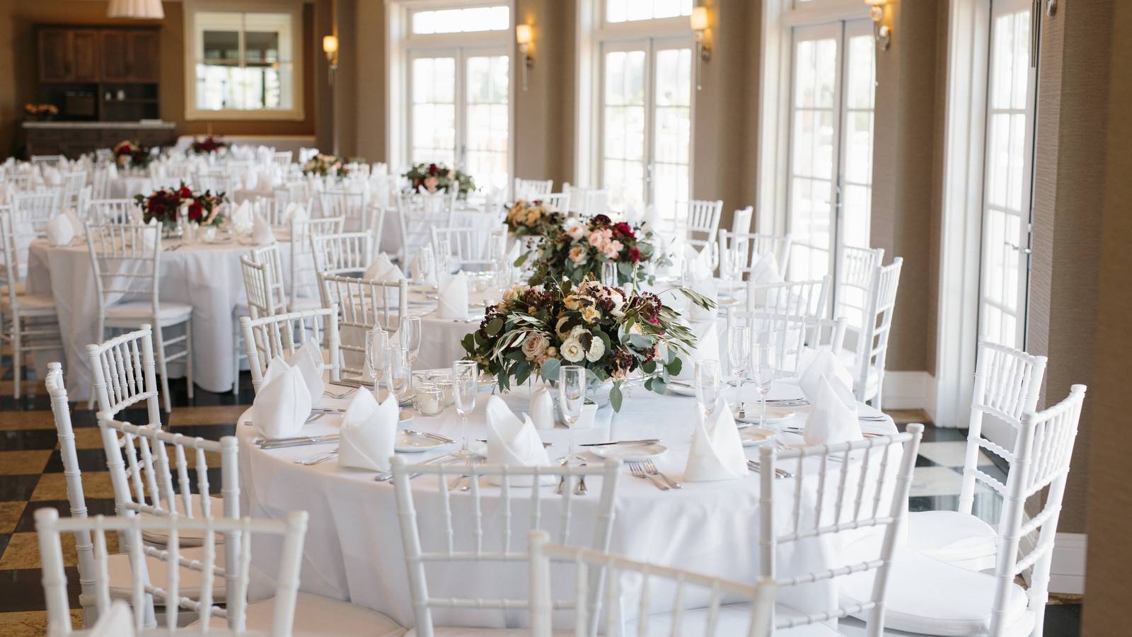 Wedding reception decor, place settings on white tables, Sagamore Room Inn at Bay Harbor