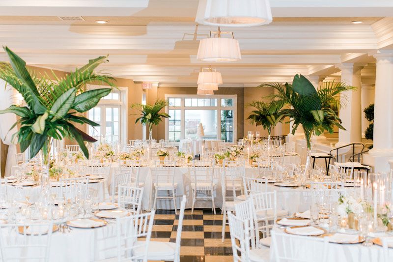 Inn at Bay Harbor wedding reception decor with tall palm leaf decor