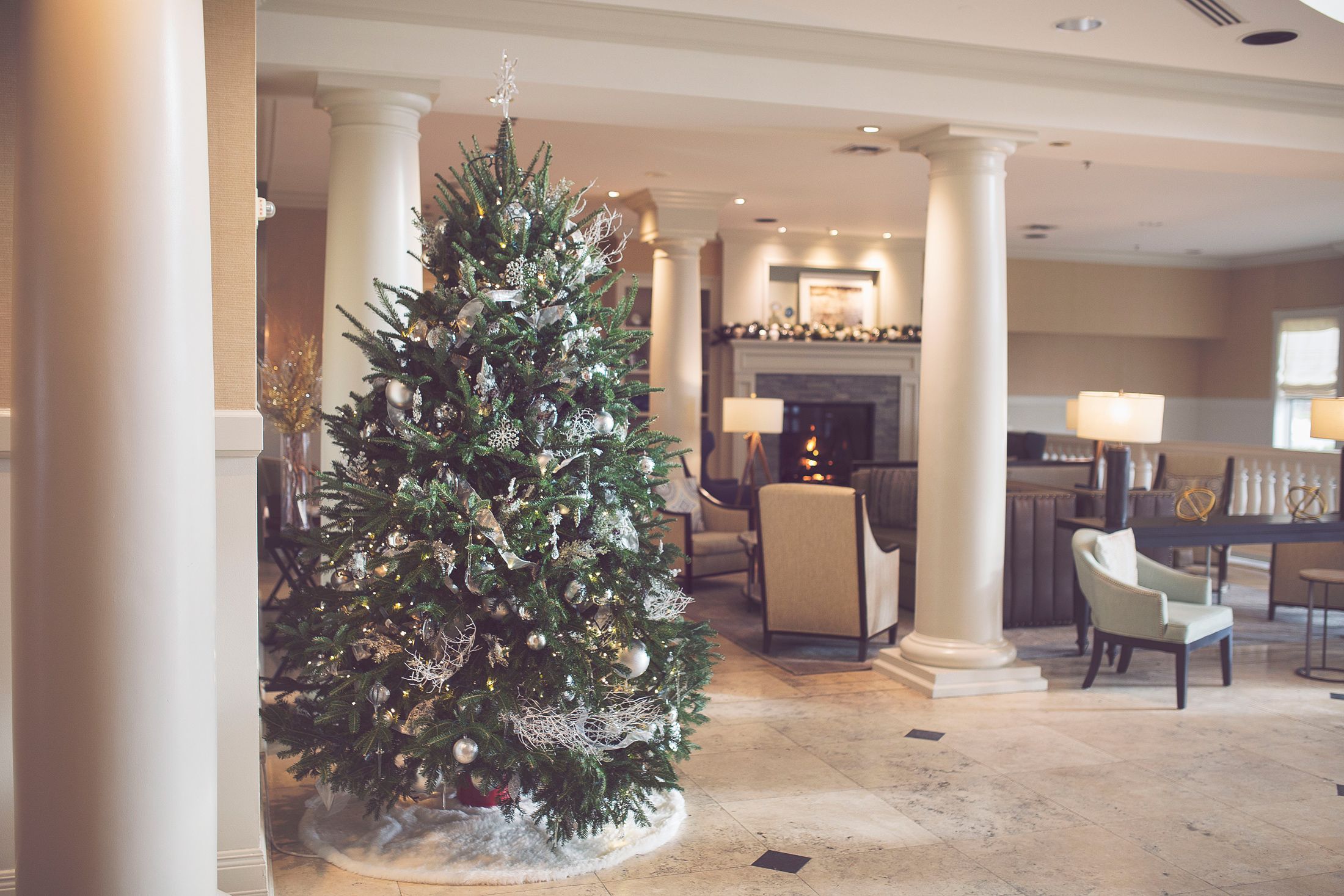 A silver and gold Christmas tree adorns the Inn at Bay Harbor lobby