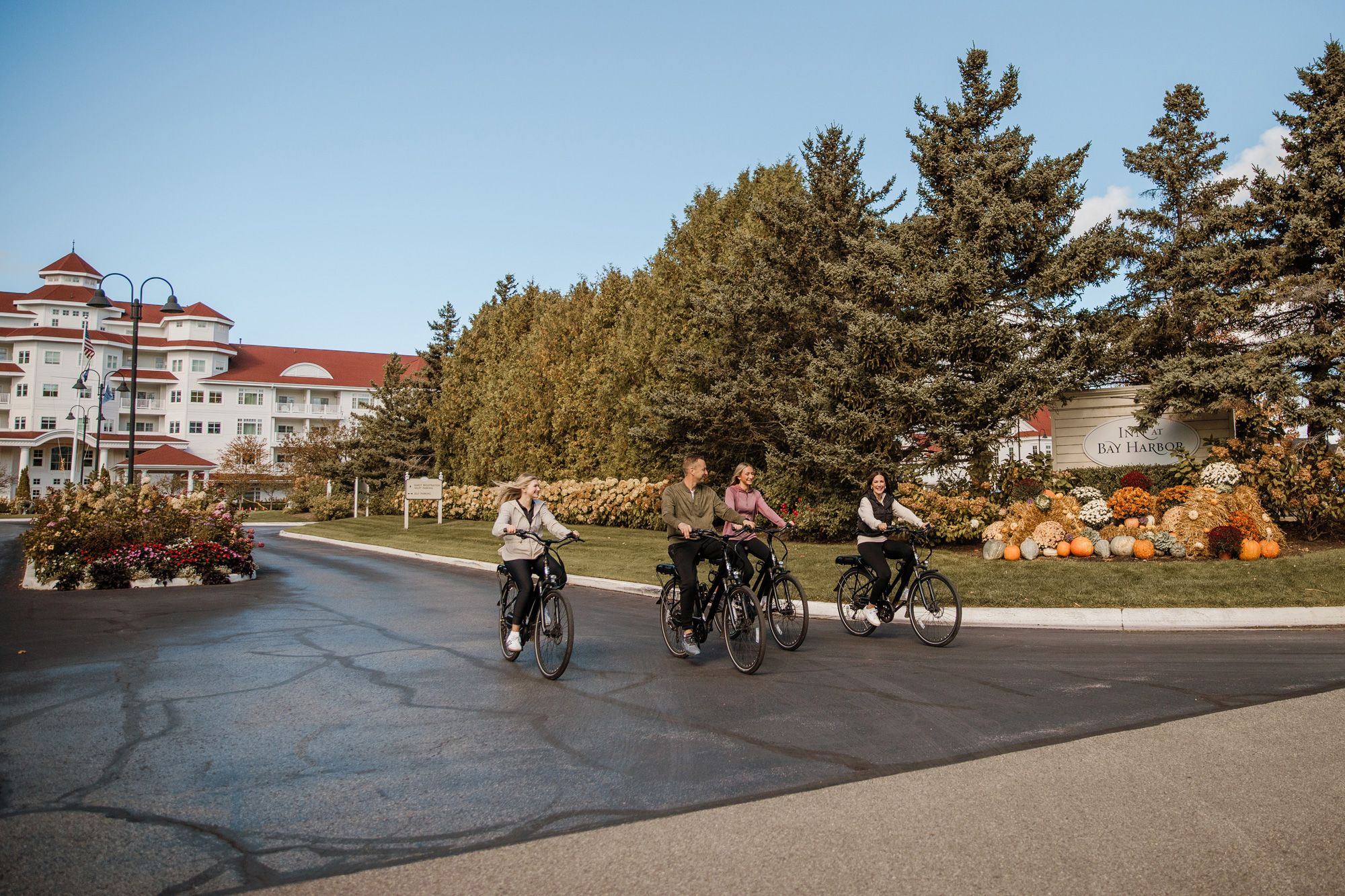 Family riding ebikes during autumn, Inn at Bay Harbor
