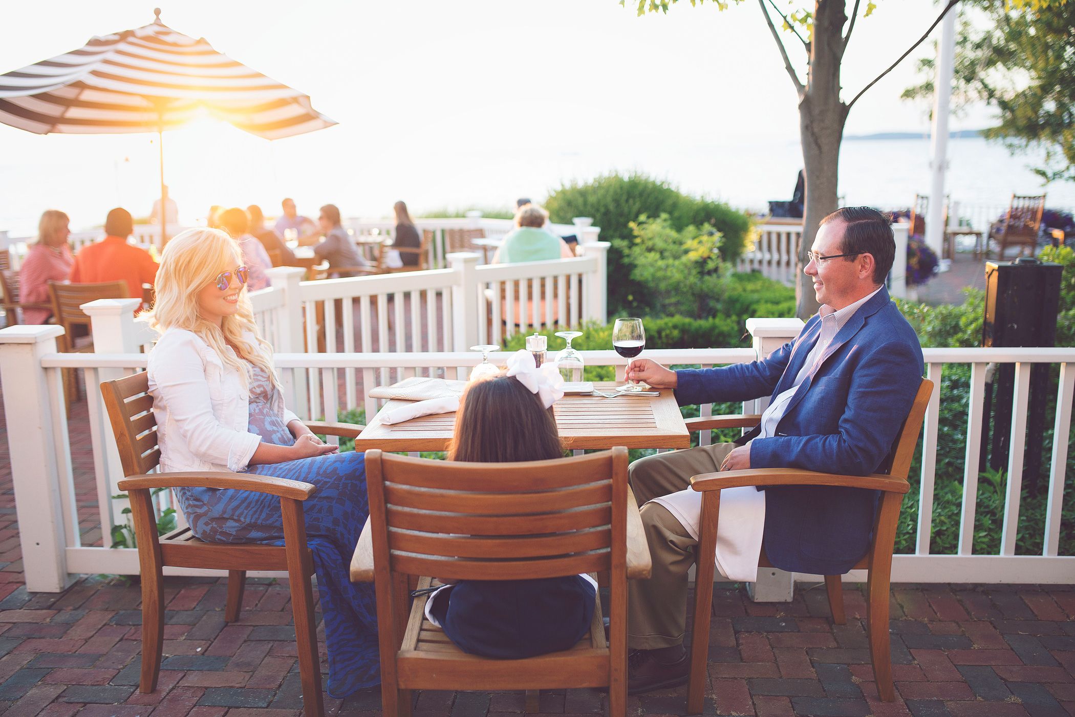 A family dine together on the patio on a summer evening