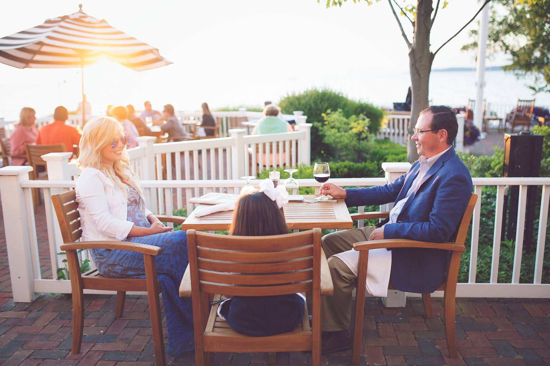 A family dine together on the patio on a summer evening