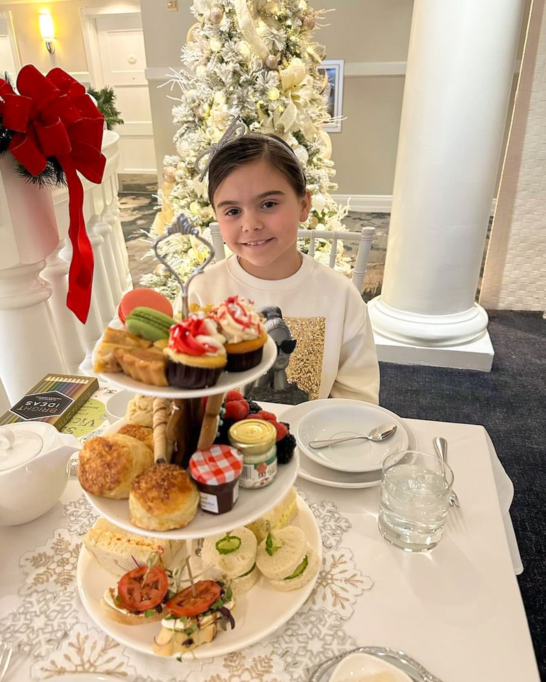 Young girl smiles during Christmas tea service, Inn at Bay Harbor