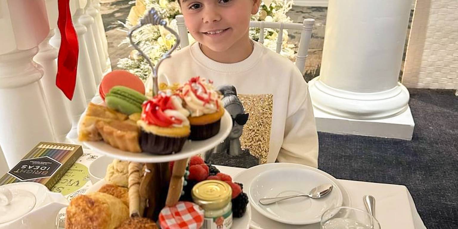 Young girl smiles during Christmas tea service, Inn at Bay Harbor