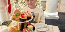 Young girl smiles during Christmas tea service, Inn at Bay Harbor