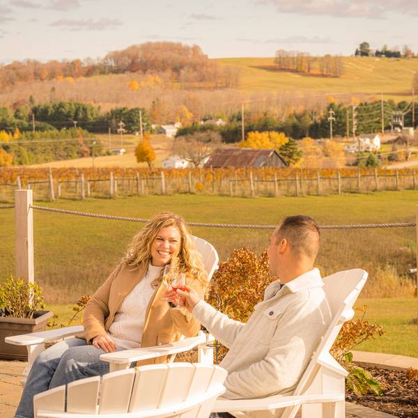 Couple toasts outdoors with wine, Petoskey Wine Region