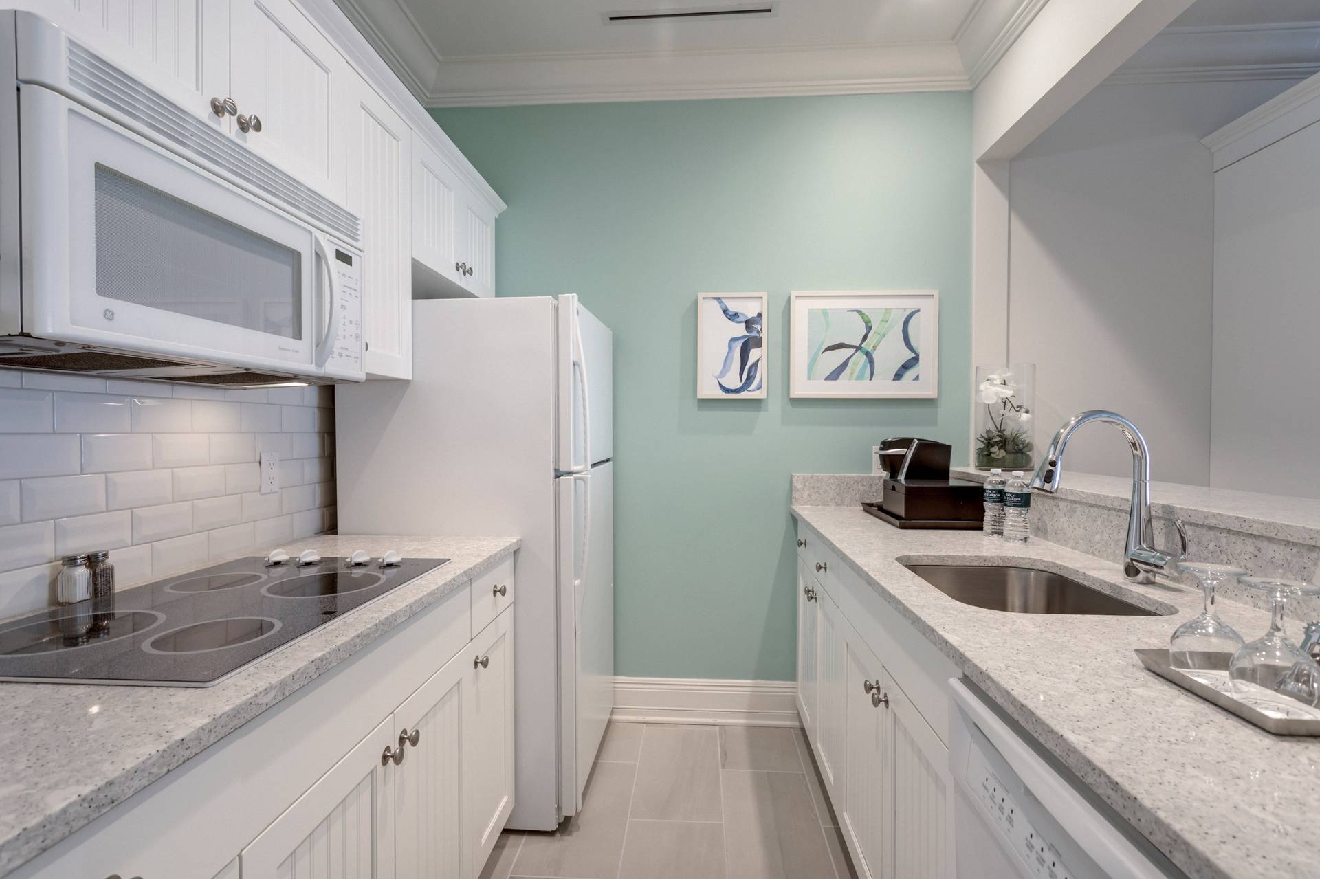 Master Suite, Inn at Bay Harbor, galley kitchen view with white cabinets, feature wall