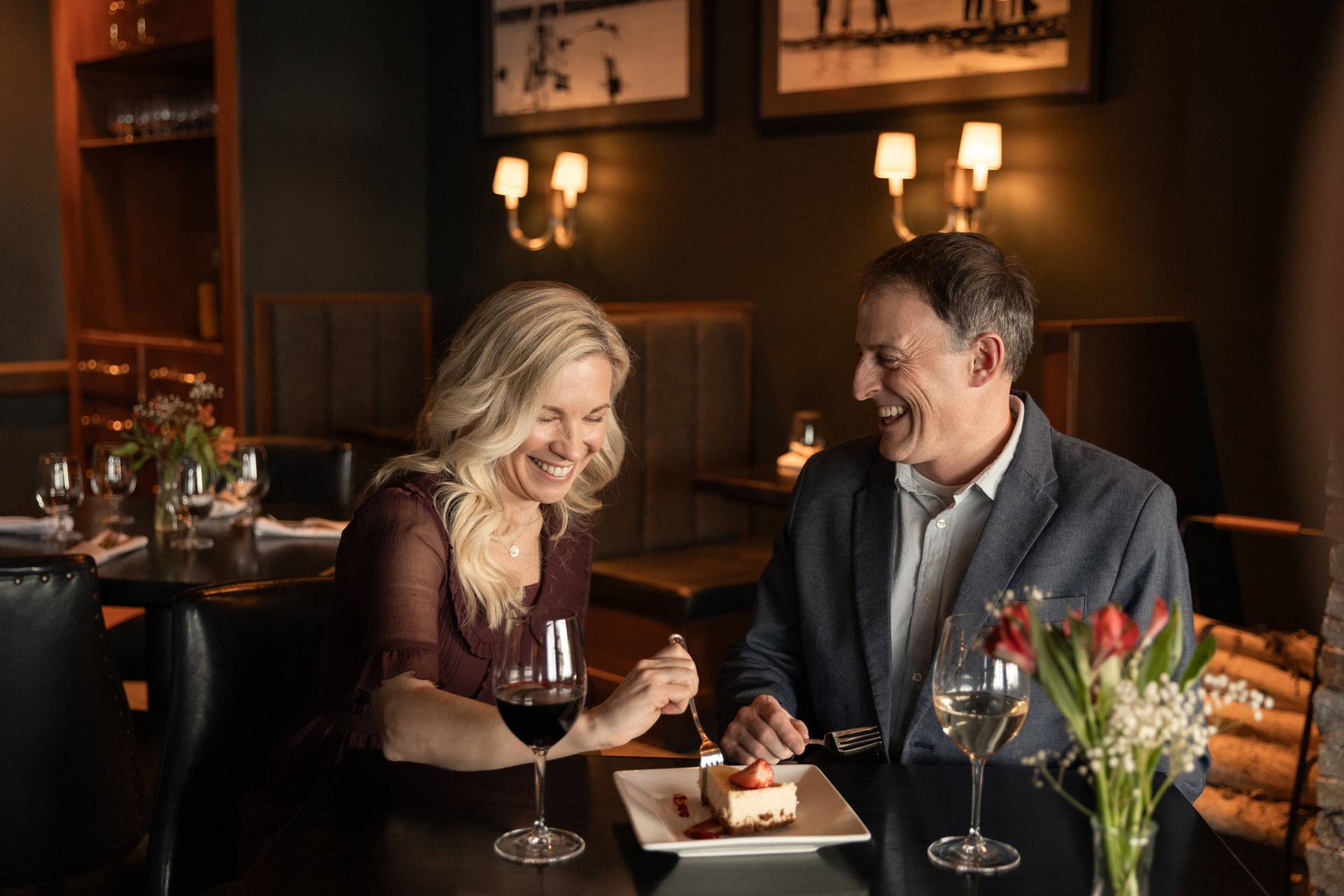 Couple with wine laughs over dessert, Vintage Chophouse at Inn at Bay Harbor