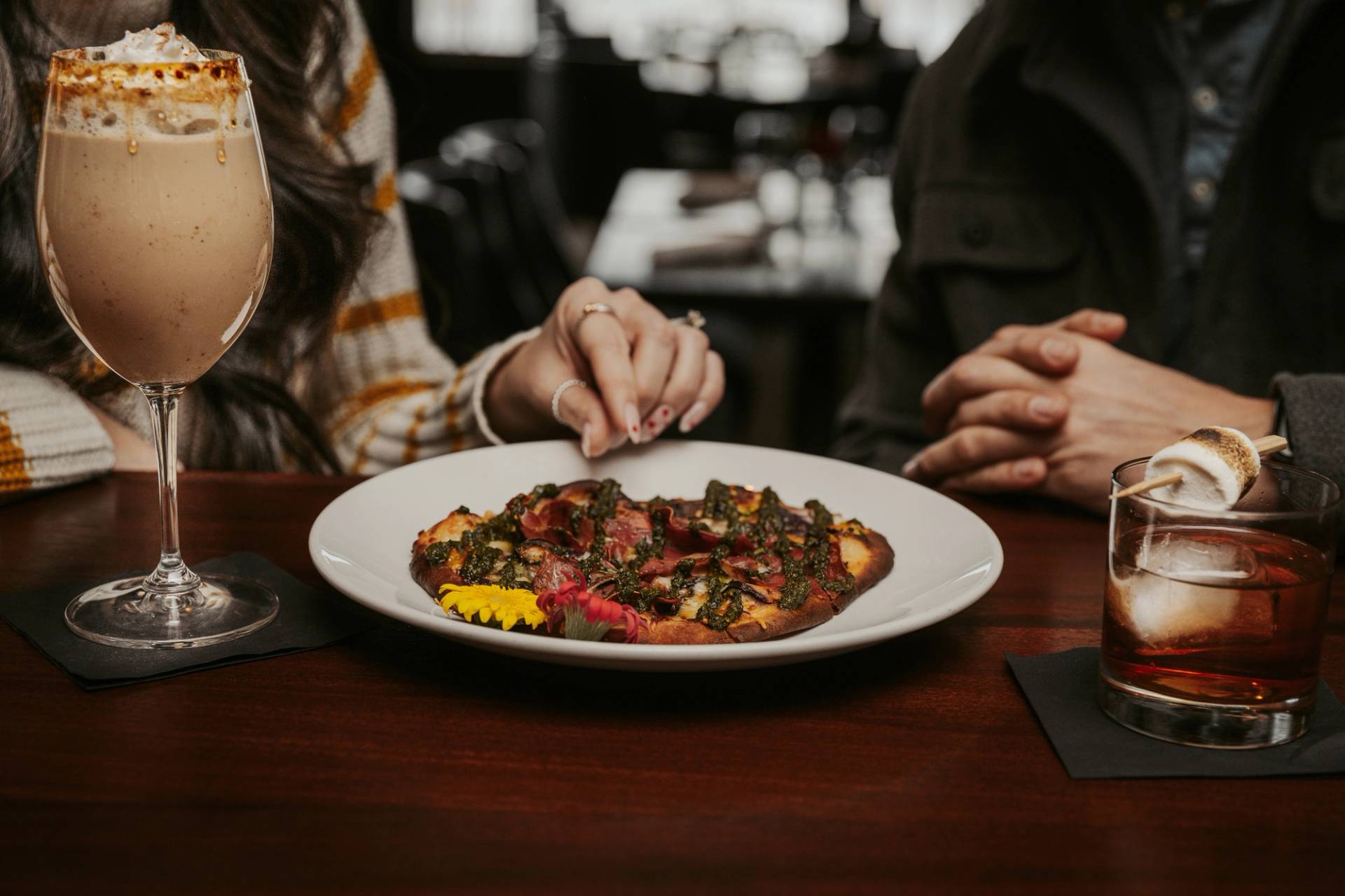 Couple enjoys cocktails with Wild Mushroom Flatbread, Vintage