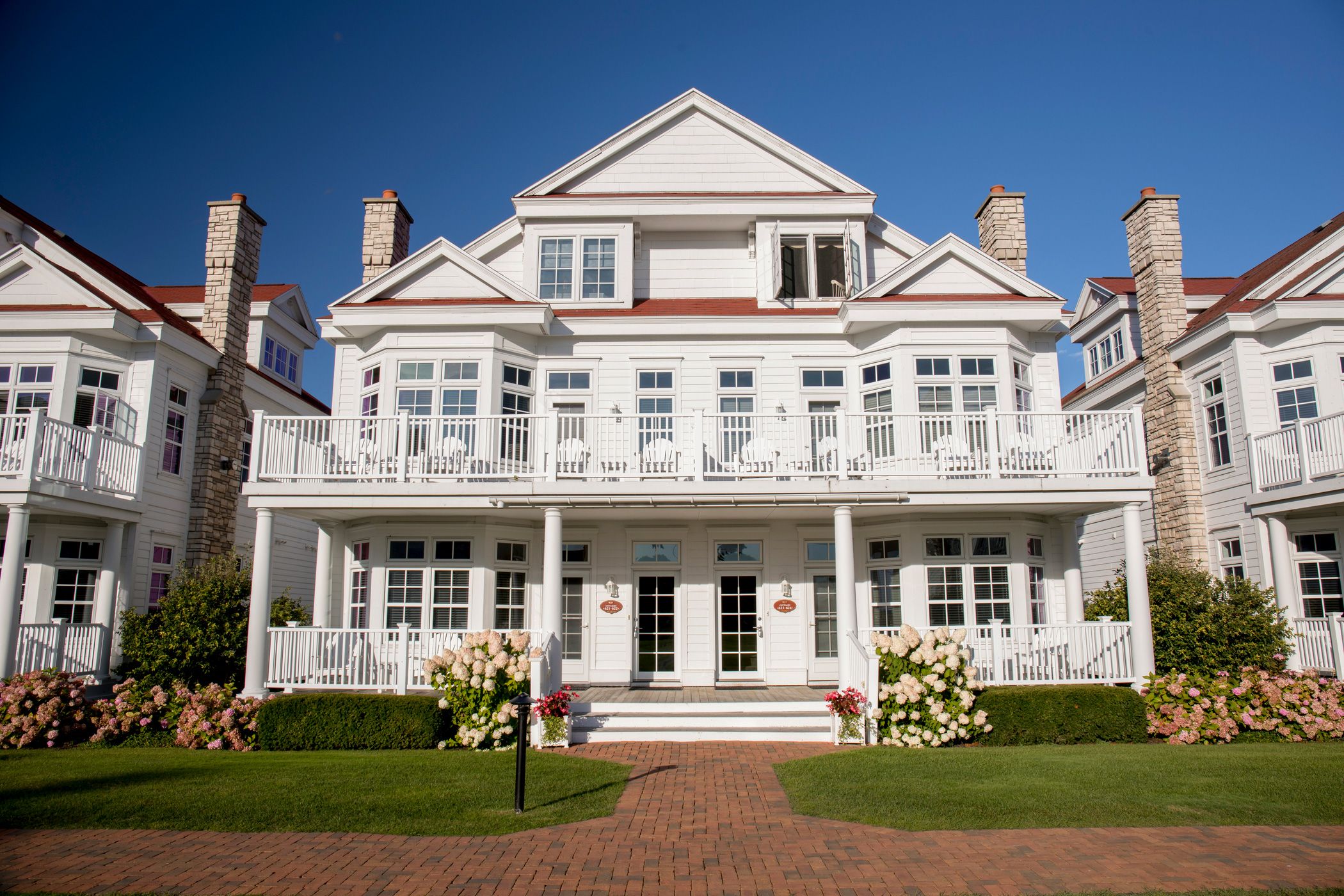 A front facing view of a Lakeside Cottage with rose bushes