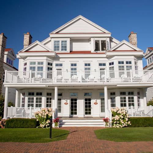 A front facing view of a Lakeside Cottage with rose bushes