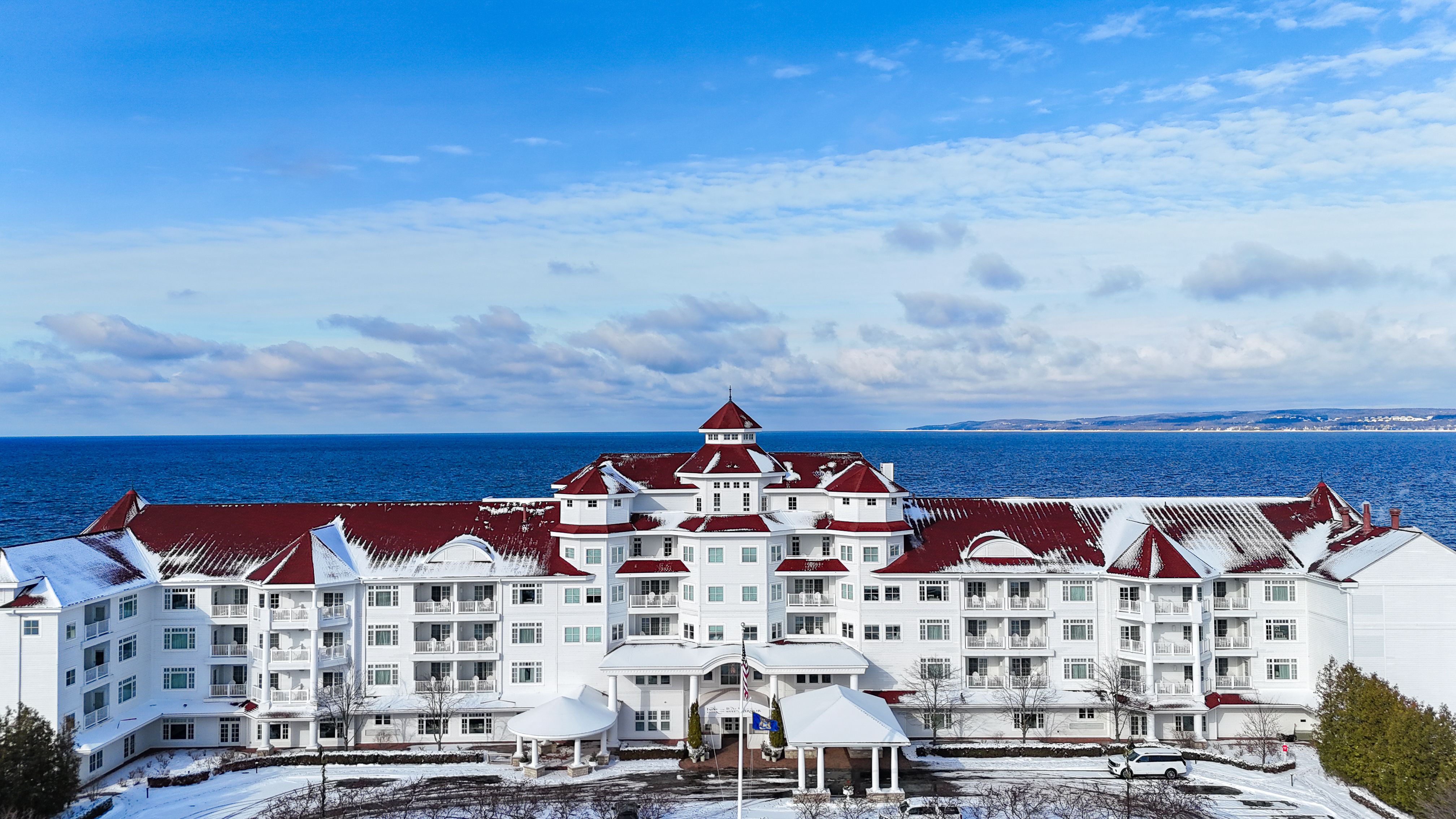 Winter exterior, Inn at Bay Harbor hotel, red roofline along blue Lake Michigan waters