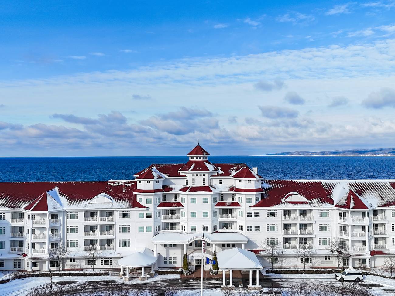 Winter exterior, Inn at Bay Harbor hotel, red roofline along blue Lake Michigan waters