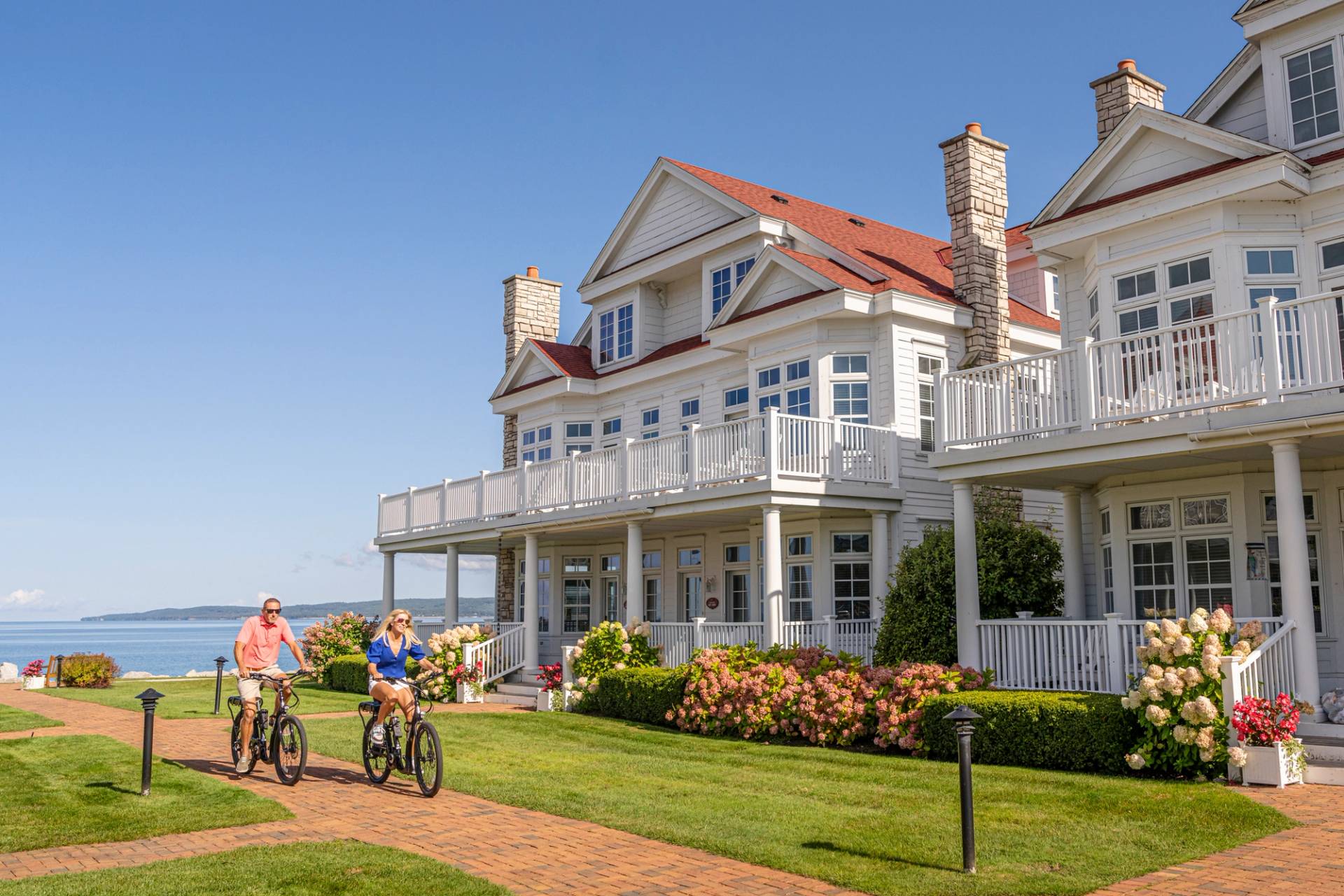 Summer couple riding bikes, Lakeside Cottages at Bay Harbor on Lake Michigan