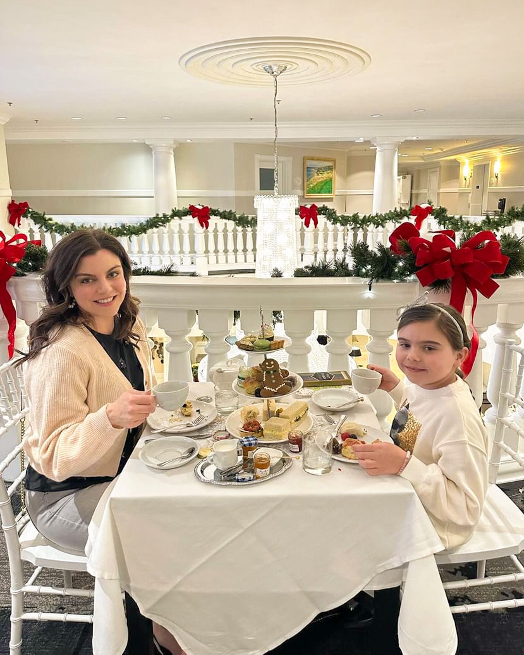 Mother and daughter smile during special Christmas tea service, Inn at Bay Harbor