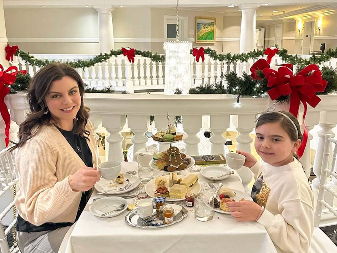 Mother and daughter smile during special Christmas tea service, Inn at Bay Harbor