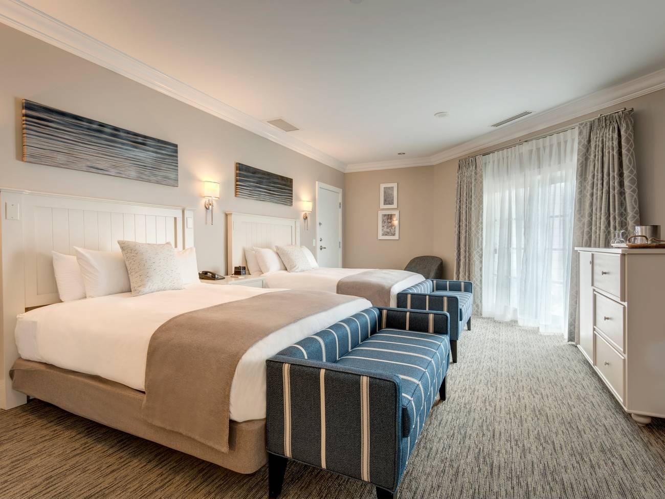 Tower Suite queen bedroom with blue benches at the end of beds