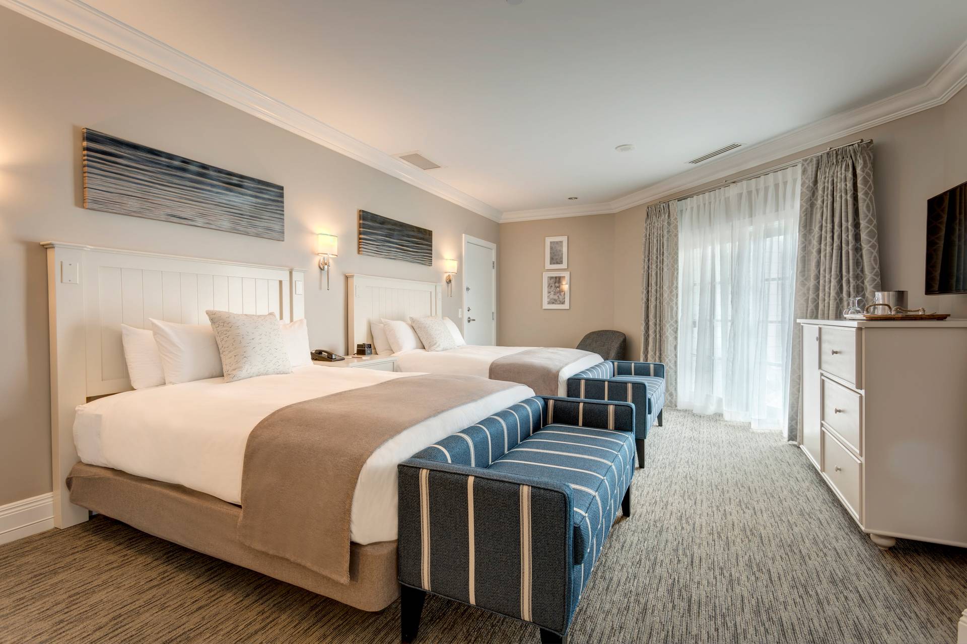 Tower Suite queen bedroom with blue benches at the end of beds