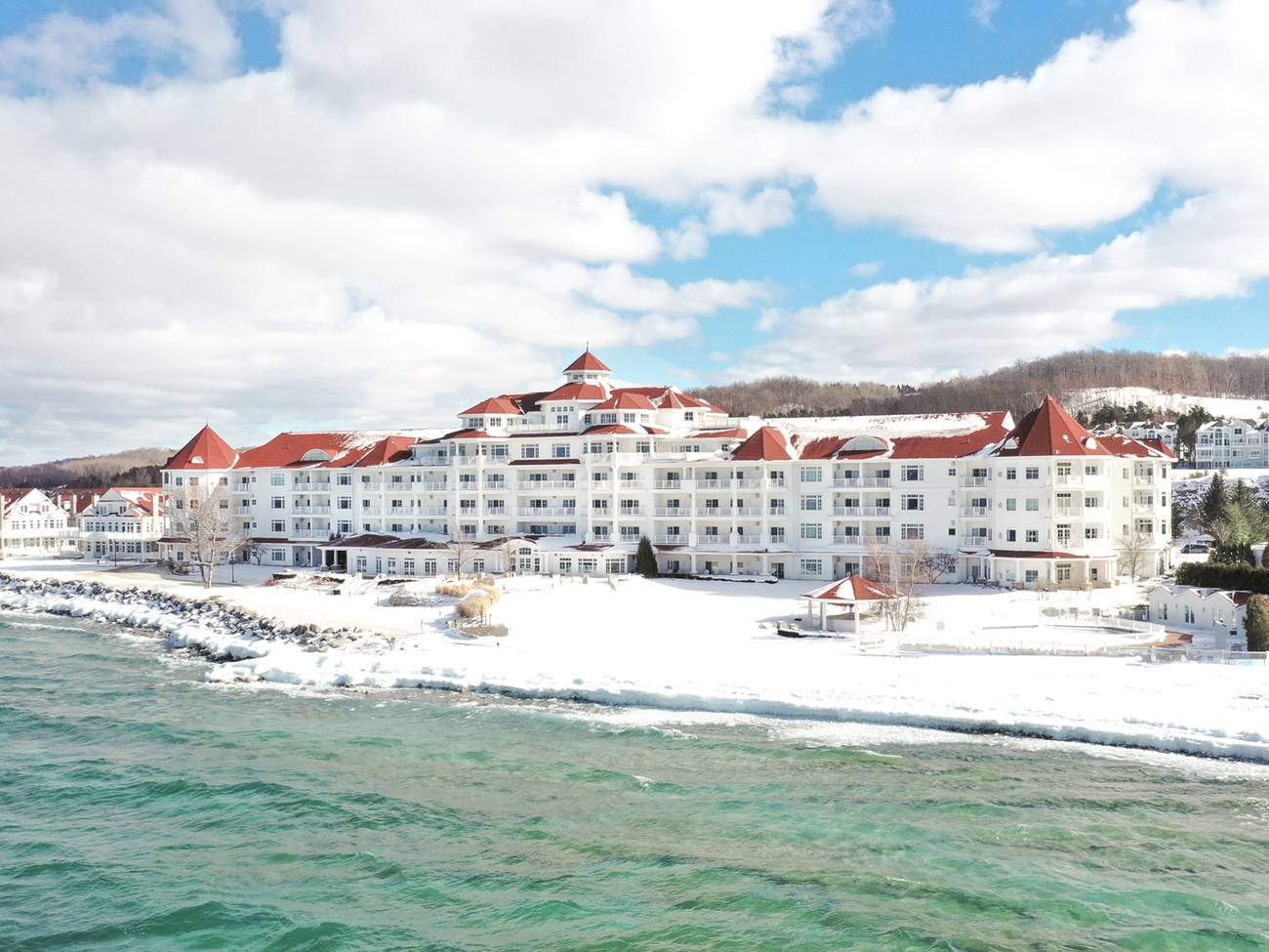 Red-roofed Inn at Bay Harbor winter exterior along snowy shores of Lake Michigan