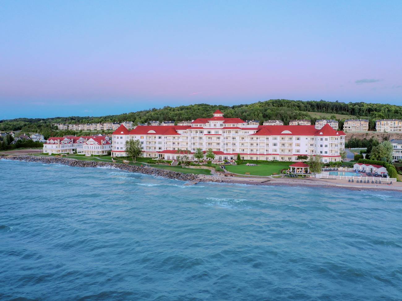 Inn at Bay Harbor exterior aerial view under dim pink and blue sunset sky