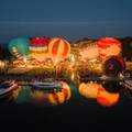 Balloons lit up in evening over Bay Harbor Lake Marina