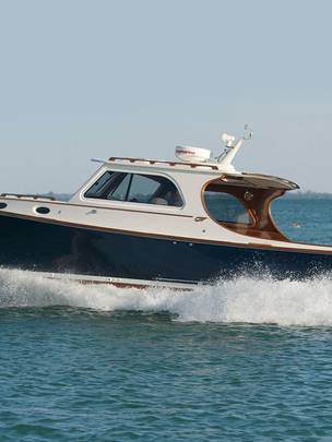 Lake Escapes Hinckley yacht speeding along water