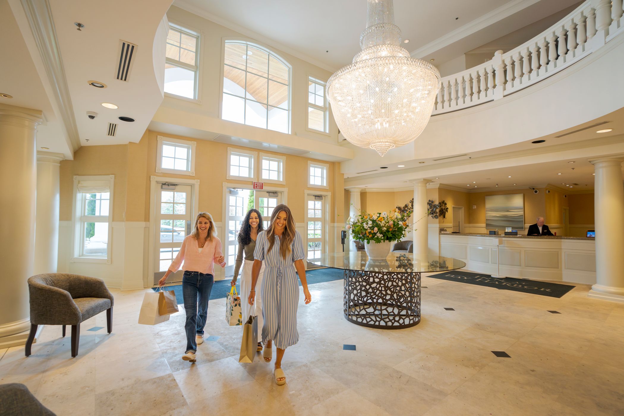 Three friends walking through a hotel lobby