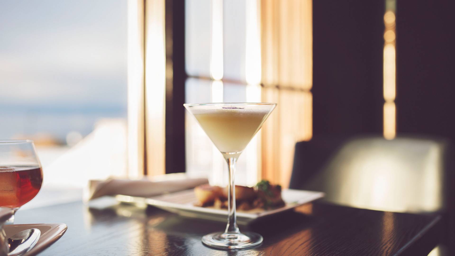 Winter cocktail detail, dinner table with snowy window seat view, Vintage Chophouse | Wine Bar