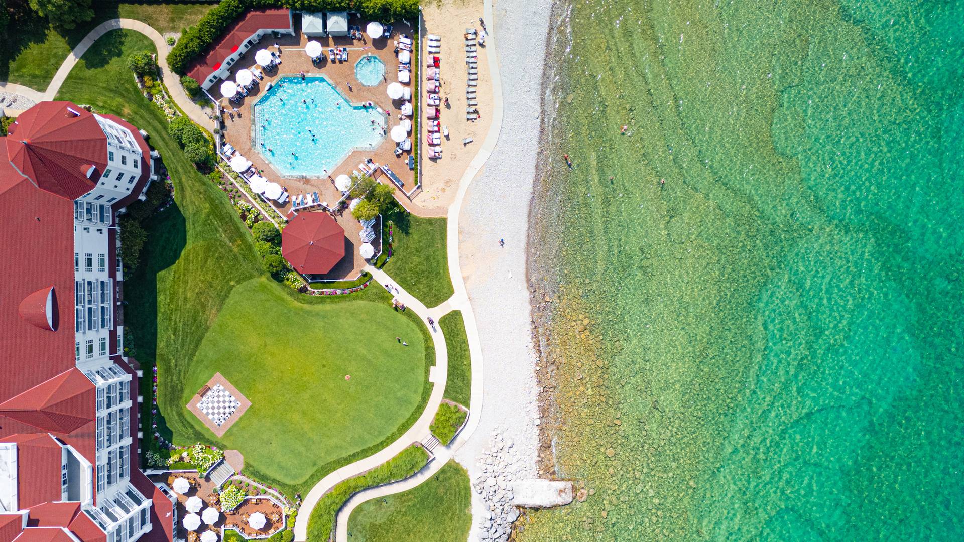 Top down view of Inn at Bay Harbor pool, grounds, and lakefront, summer