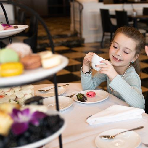Little girl with tea cup, Inn at Bay Harbor afternoon Tea