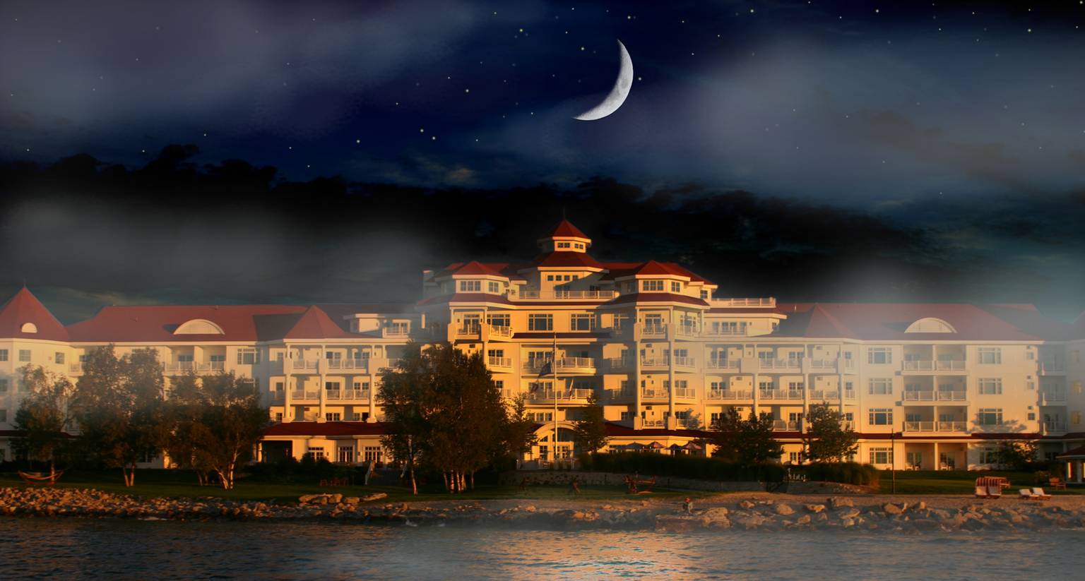 Spooky rendering of crescent moon over dark night at Inn at Bay Harbor