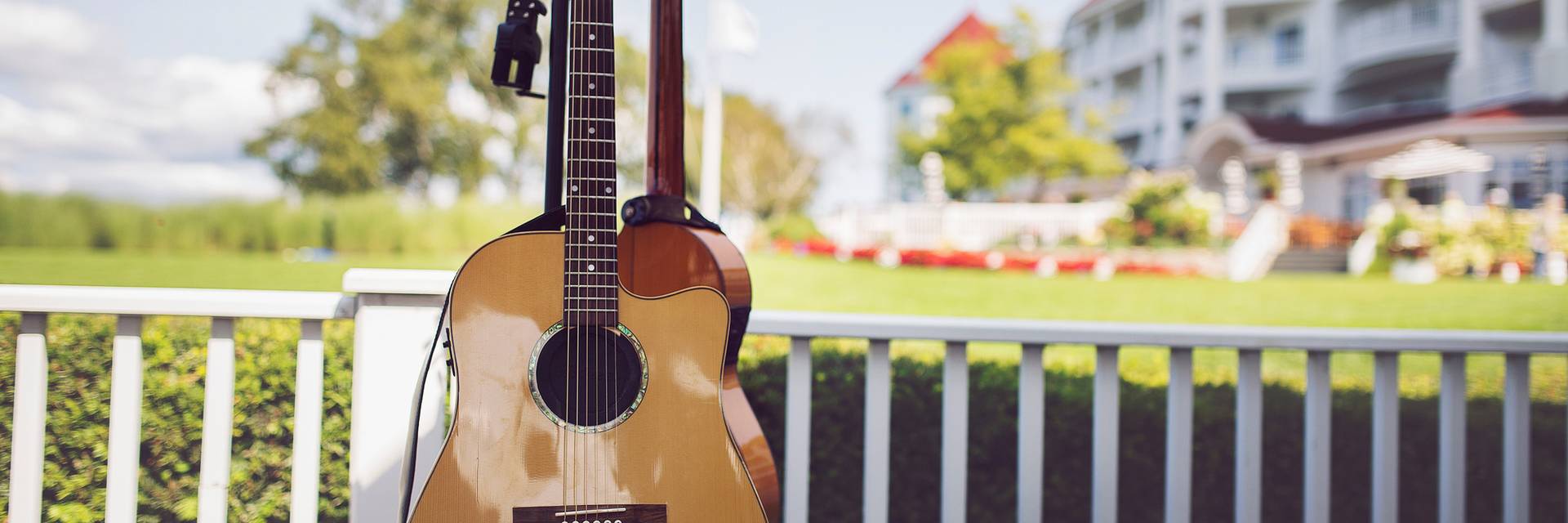 Acoustic guitar displayed on stand on outdoor patio of Inn at Bay Harbor